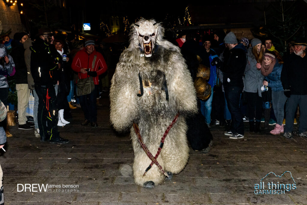 a Krampus performer dressed in white furs at the traditional parade in Berchtesgaden, Germany